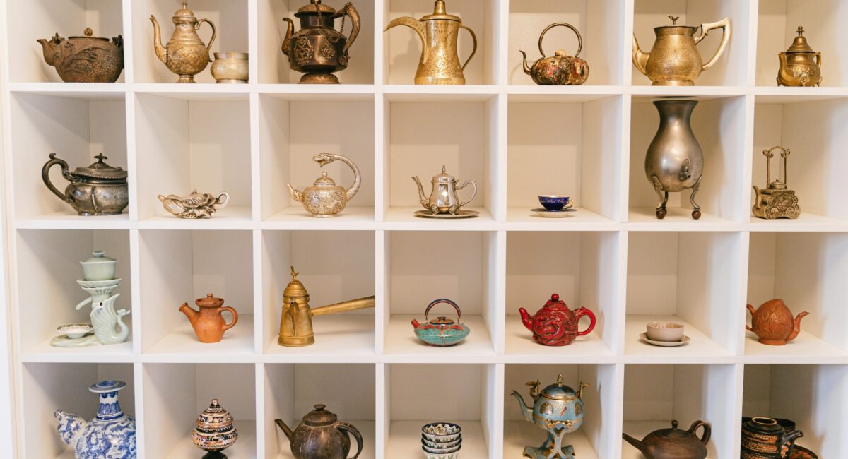 A Variety of Teapots in a Shelf